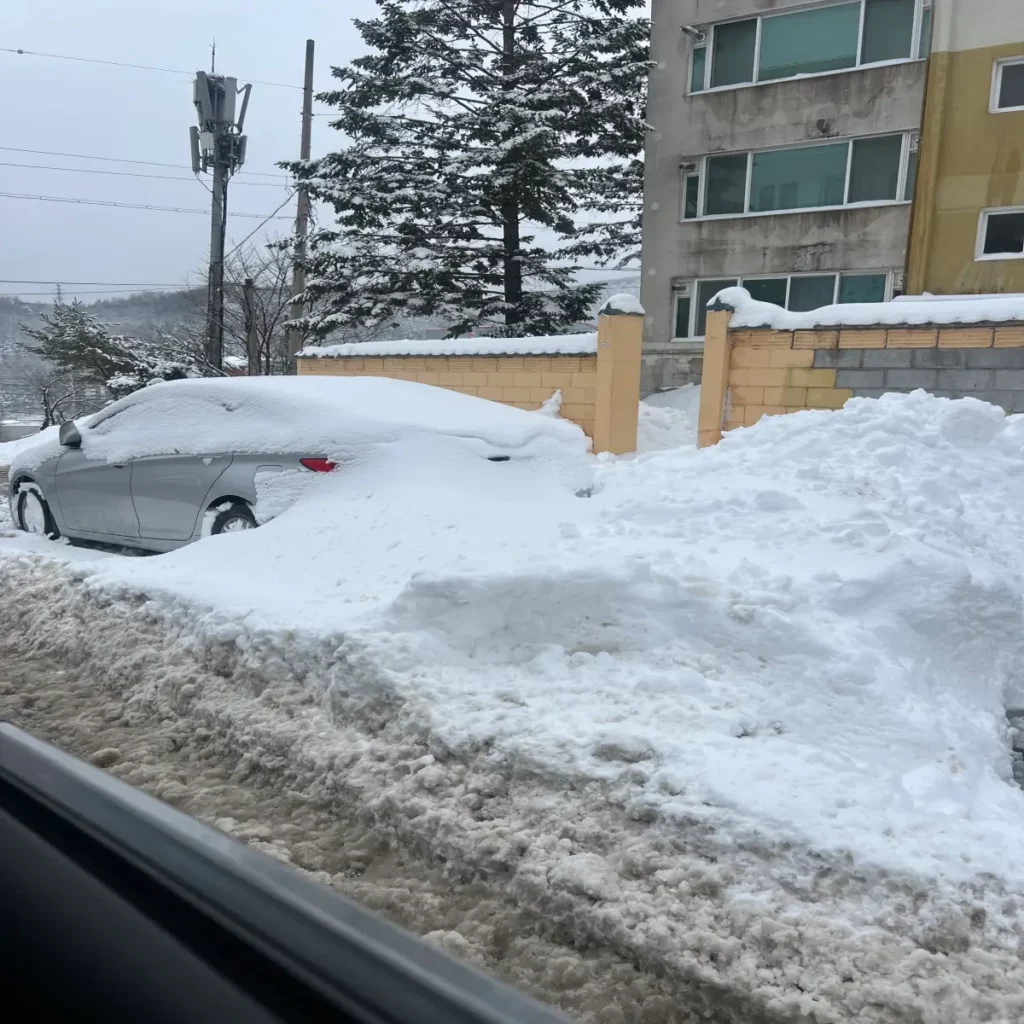 자동차-주변으로-쌓인-많은-양의-눈